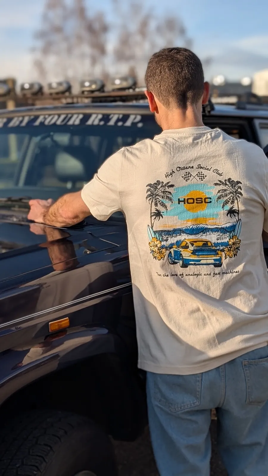 993 GT2 Tee worn, leaning on a Jeep, back print in the sun