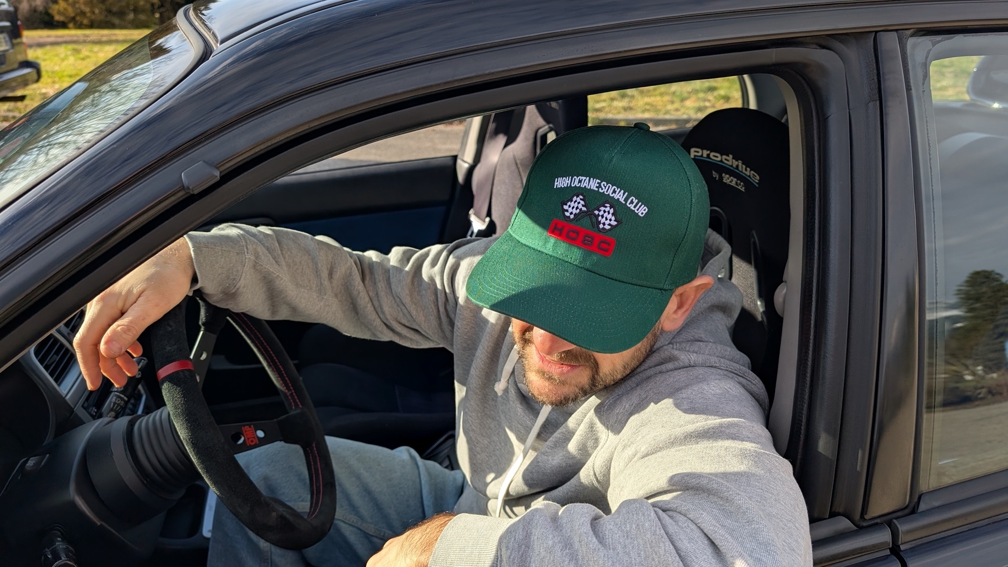 Racing Green Cap, in the car with a suede wheel