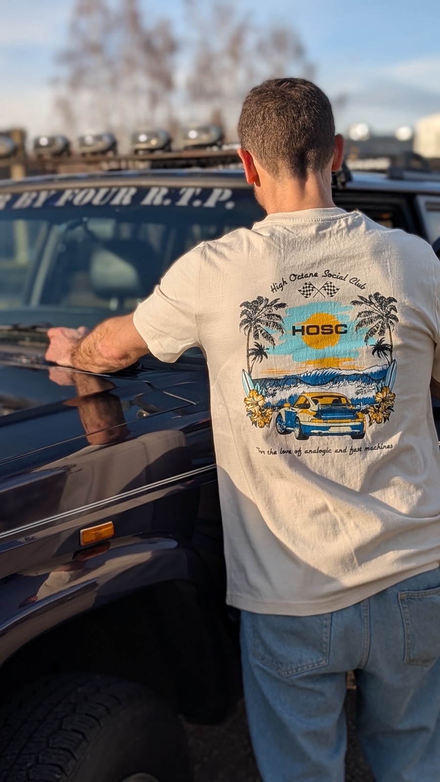 993 GT2 Tee worn, leaning on a Jeep, back print in the sun